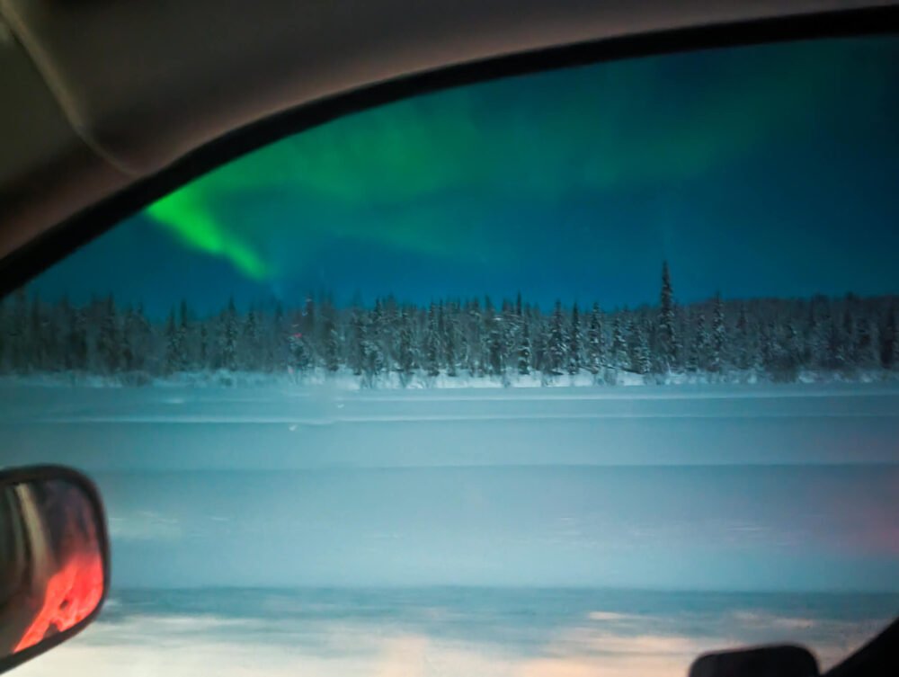 A view of the aurora borealis taken through a car window