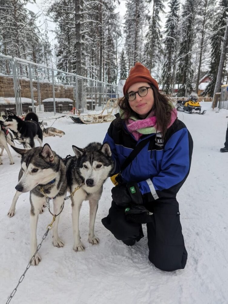 Allison Green with her team of sled dogs after the run, meet and greet with huskies