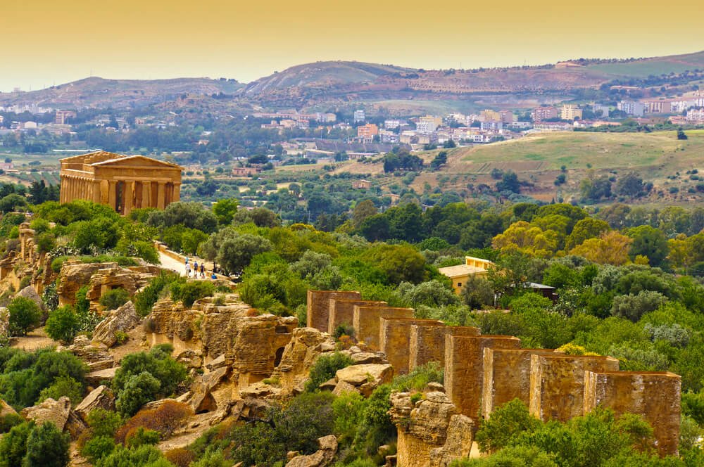 sunset over the ruined greek city landscape of valley of the temples in agrigento sicily