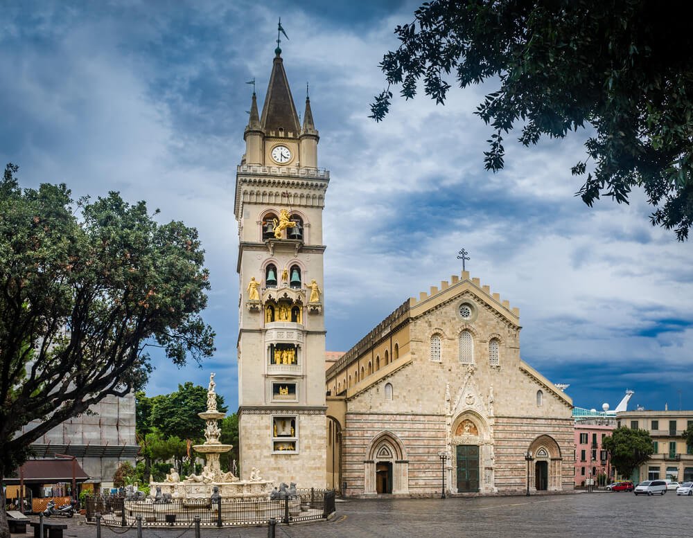 The central cathedral of messina with a large belltower and clock