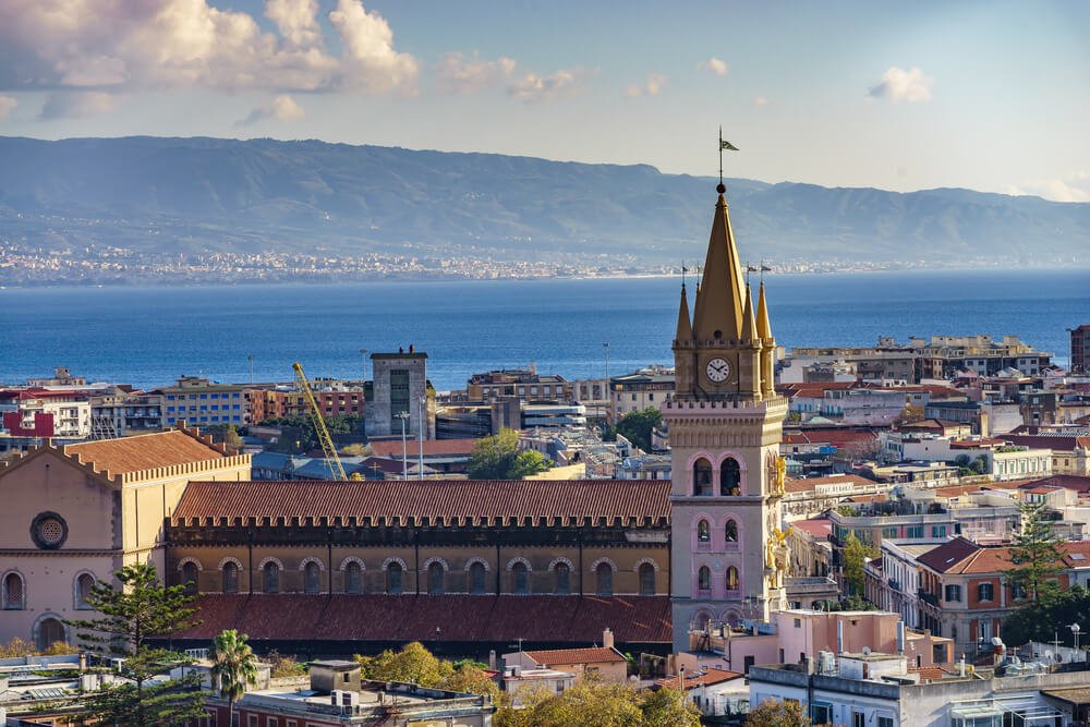 The landscape of Messina, Sicily; view of the stunning Church of the Madonna di Montalto, set on the hill Caperino in the town, with a view of the sea in the background.