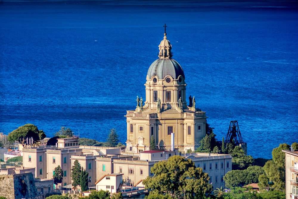 The building of  Temple Christ the King in Messina with the strait of messina in the background