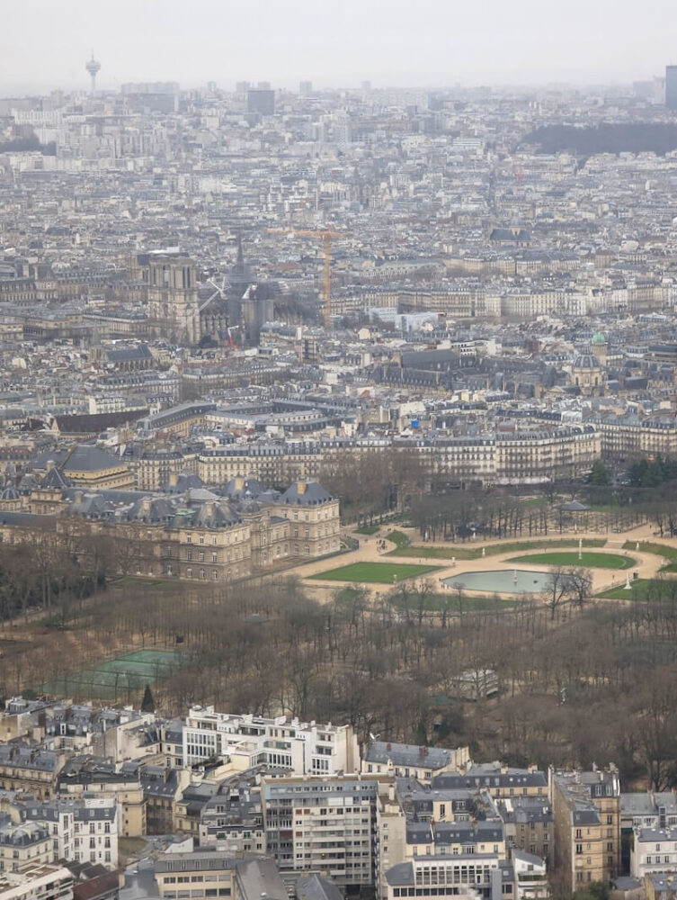 Giant park and fancy building as seen from the top of the Montparnasse Tower