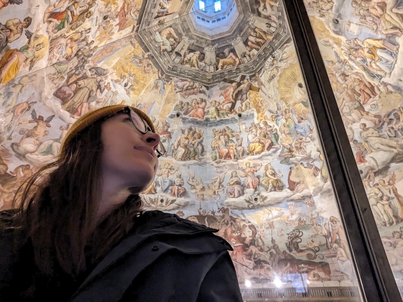 Allison Green, author of the article, looking up at the ceiling with its beautiful frescoes