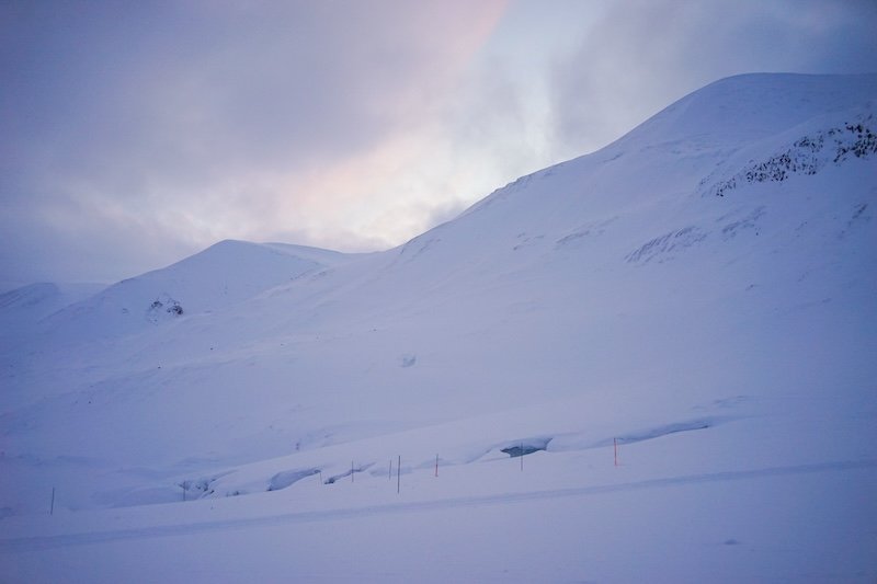 View of the mountains in blue hour with a slight bit of pink in the clouds