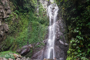 Beautiful view of the waterfall tumbling down the cliff in Bali