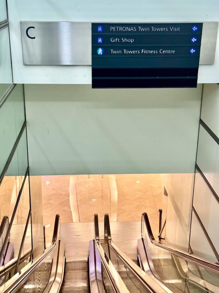 Escalators going down one level to the ticketing area at Petronas Towers
