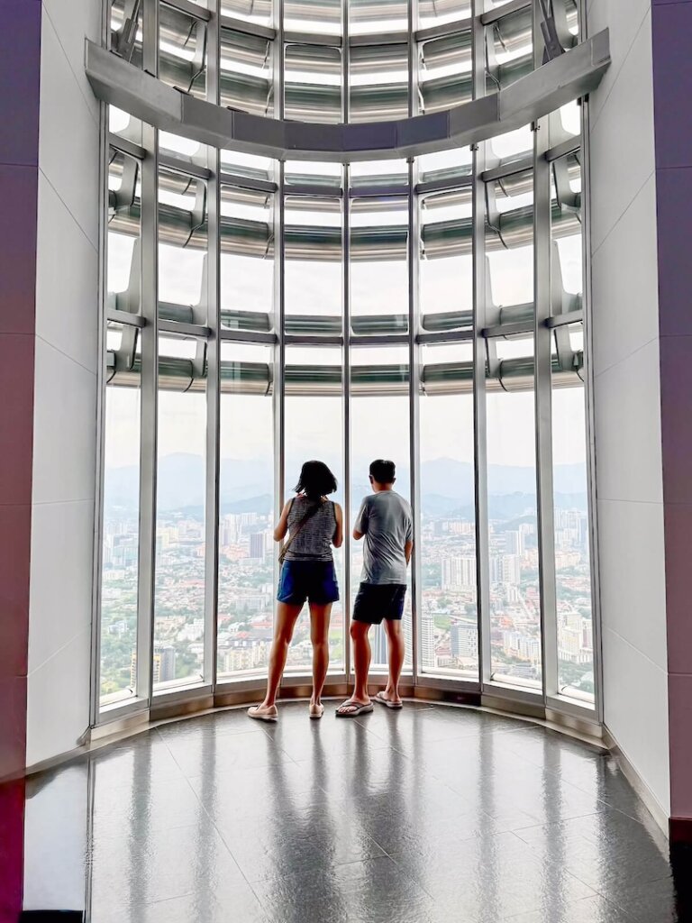 People looking out one of the panoramic views at the top of the Petronas Towers