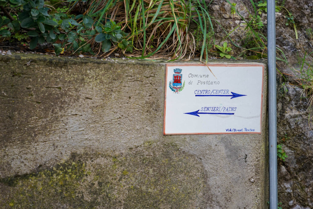 A sign pointing towards the hiking trails vs the center of town