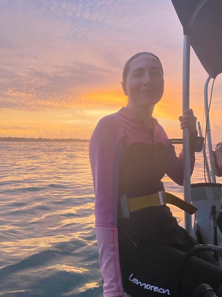 Allison Green sitting on a dive boat in Bocas del Toro