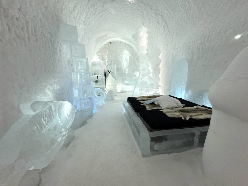 Interior of the Ice Hotel 365 with bed and ice sculptures