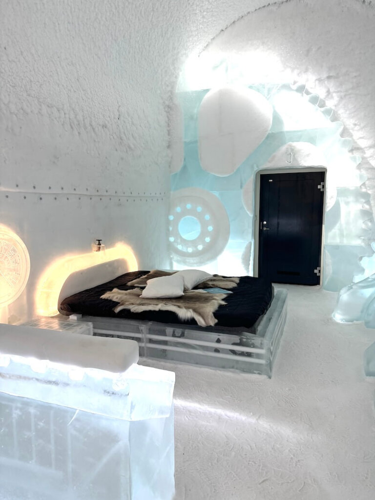 Interior of the ice hotel 365 with reindeer pelts on an ice bed in jukkasjarvi at the icehotel