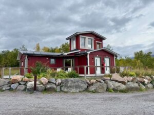 Exterior building of Abisko Mountain Lodge which has a few guestrooms in a red building