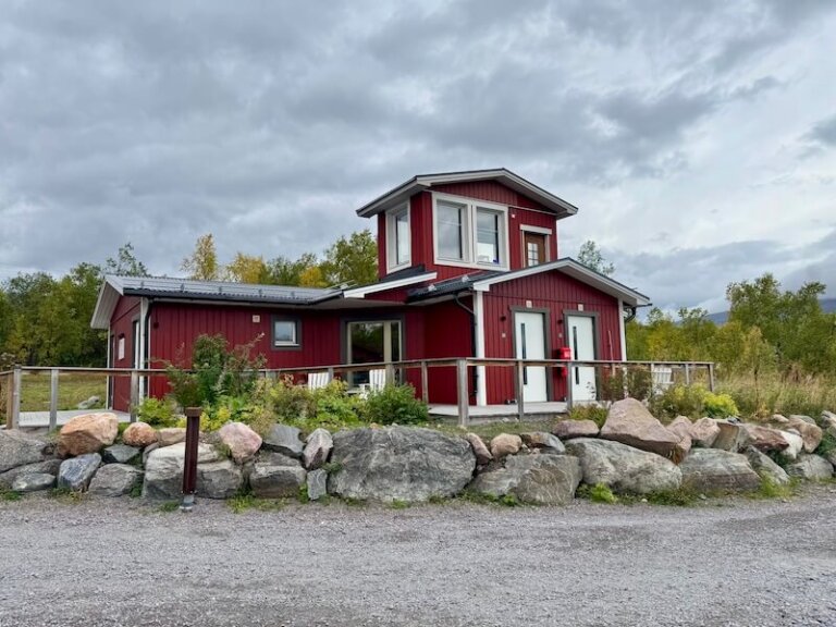 Exterior building of Abisko Mountain Lodge which has a few guestrooms in a red building