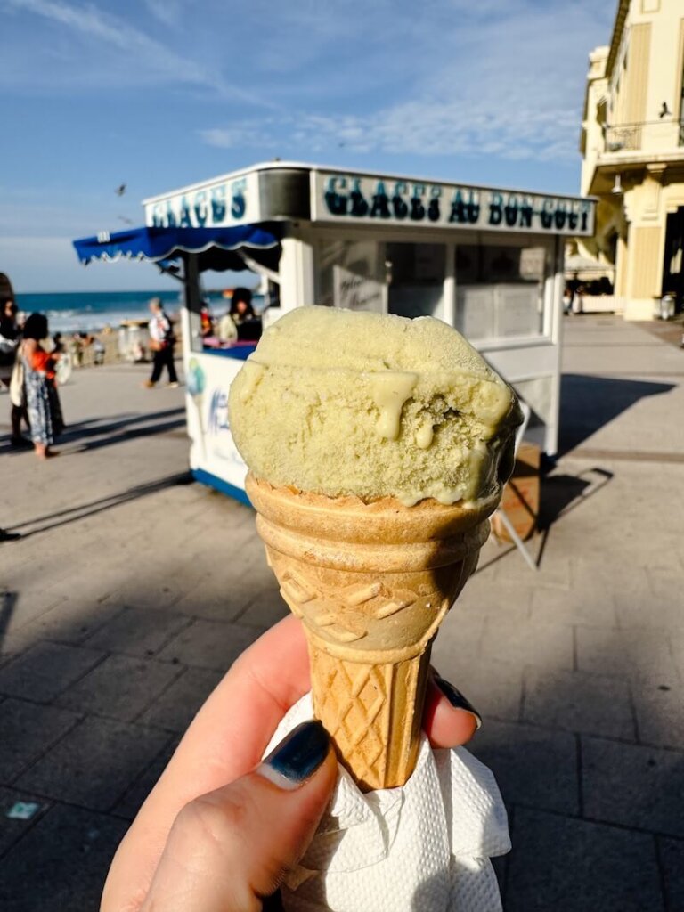 A cone of pistachio ice cream at the local favorite with a vintage aesthetic called "glaces au bon gout" which is french for ice cream with good taste