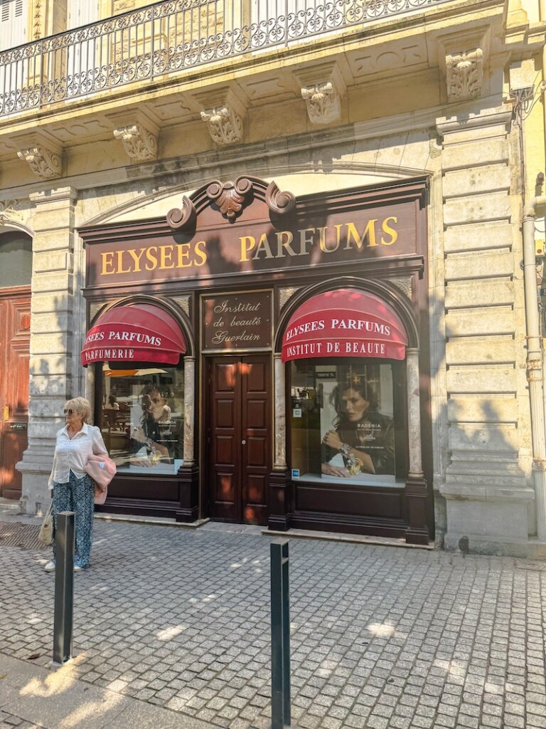 A famous perfume shop in Biarritz called Elysees Parfums which has a lot of beautiful scents you can purchase with an elegant woman standing outside