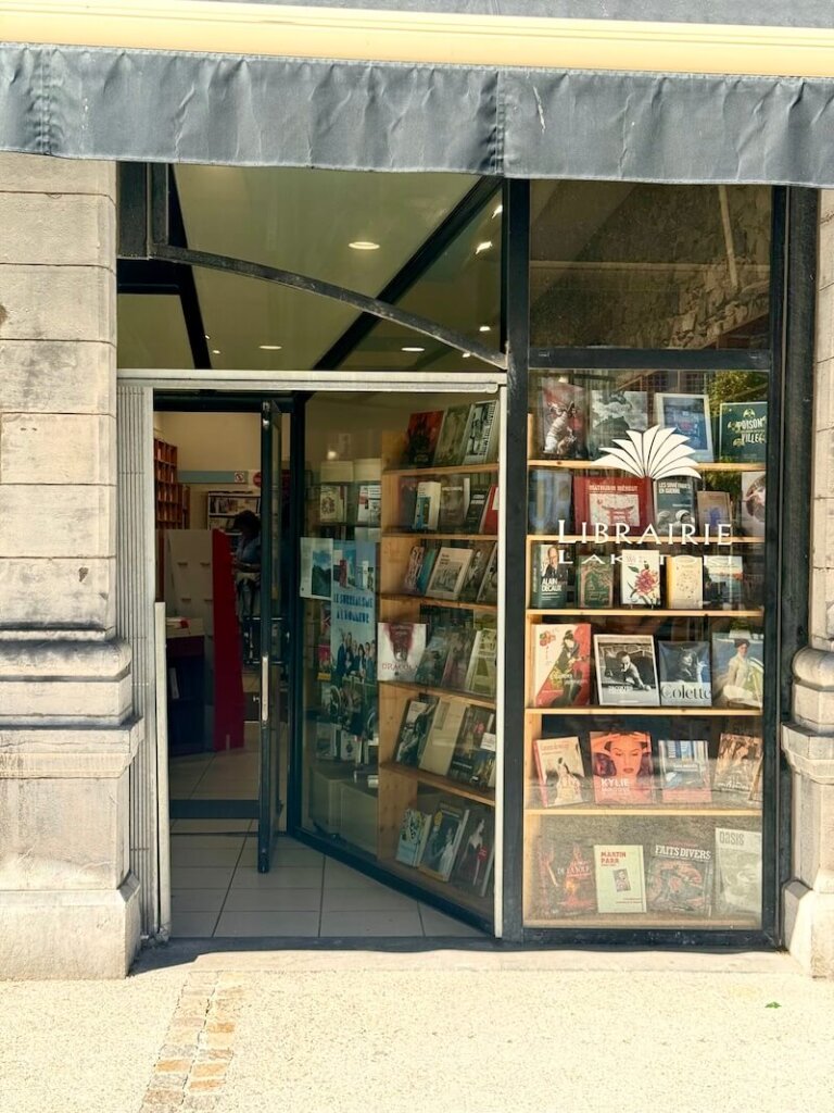 Facade of a French bookstore called Librarie Laketoki with books and charming entryway