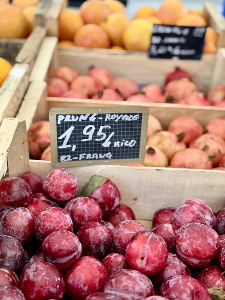 Prunes and plums and other fresh produce for sale from local fruit sellers in France
