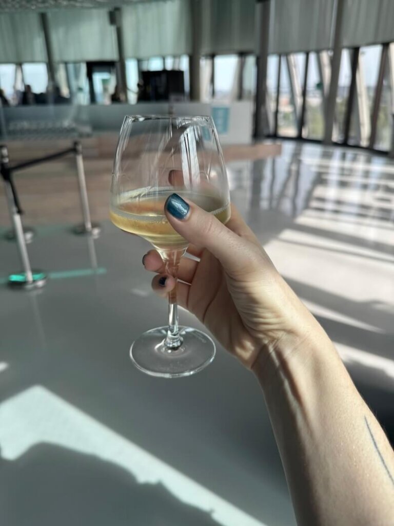 Allison's hand holding a glass of wine in Bordeaux