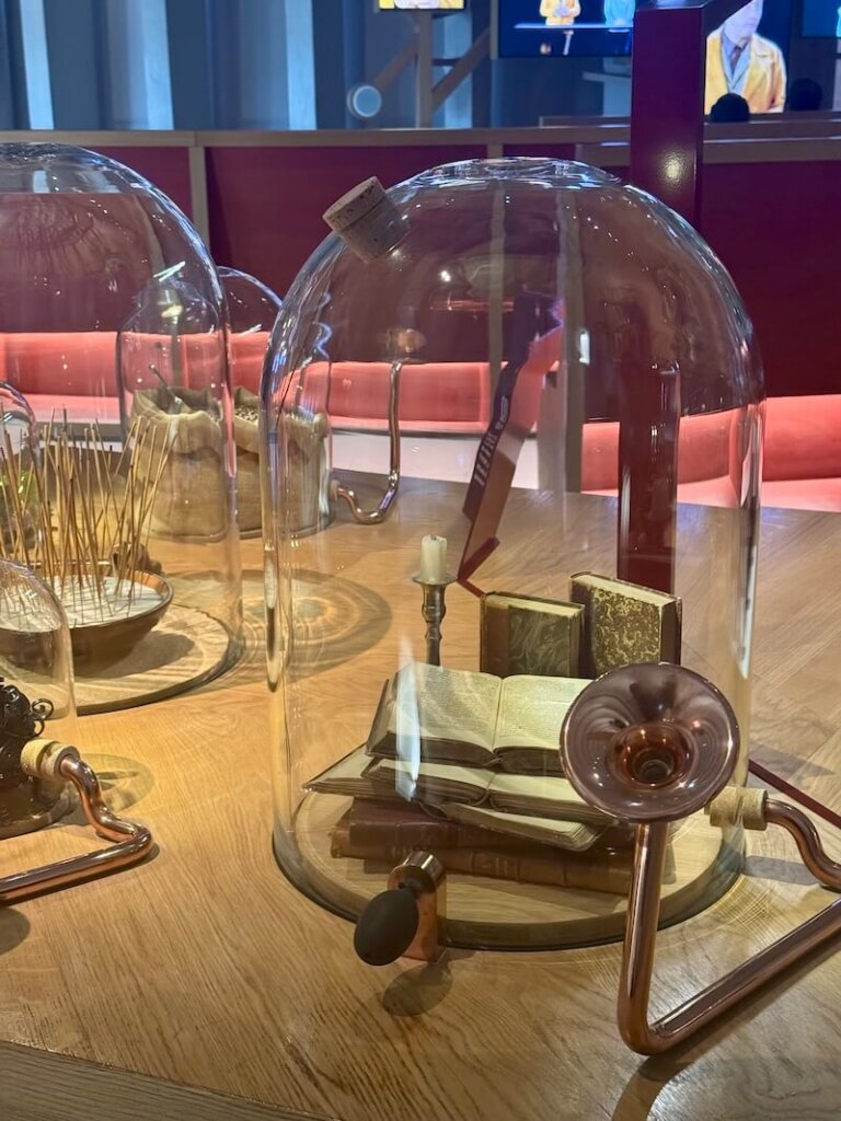Some books in a jar which allow you to smell the aroma of leather bound books