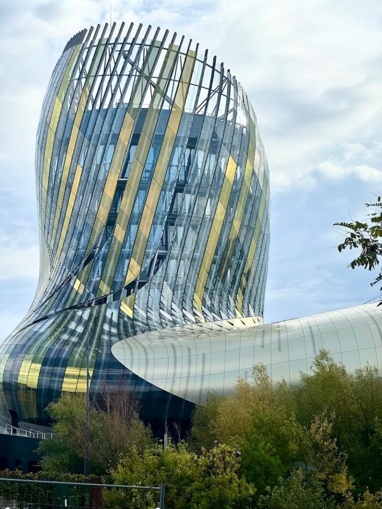 Gold and blue colored panels of glass in a swirling, fluid motion evoke water in this modernist building