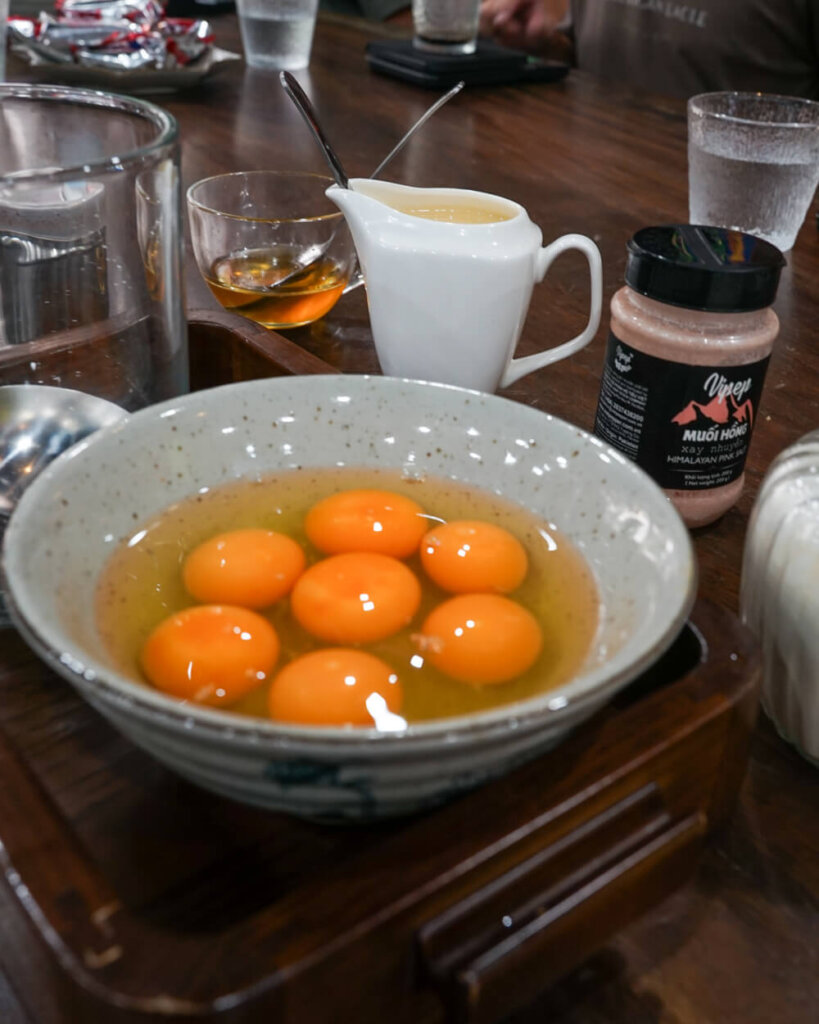 The ingredients for egg coffee including egg yolk, condensed milk, honey, and mung bean powder