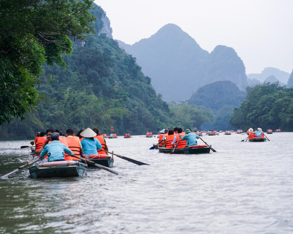 Trang An river with boats and mountains