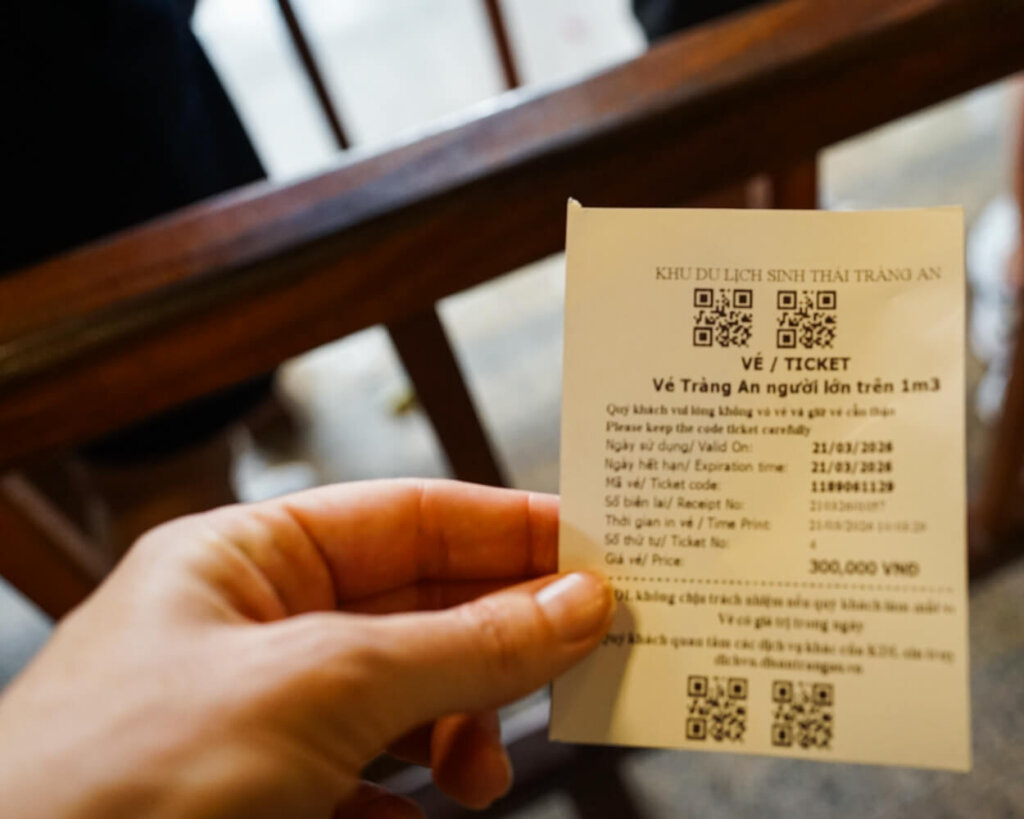 Allison's hand holding the Trang An boat ticket