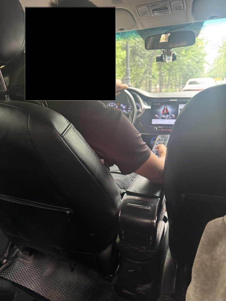 Man driving and texting and looking at another screeen as well 