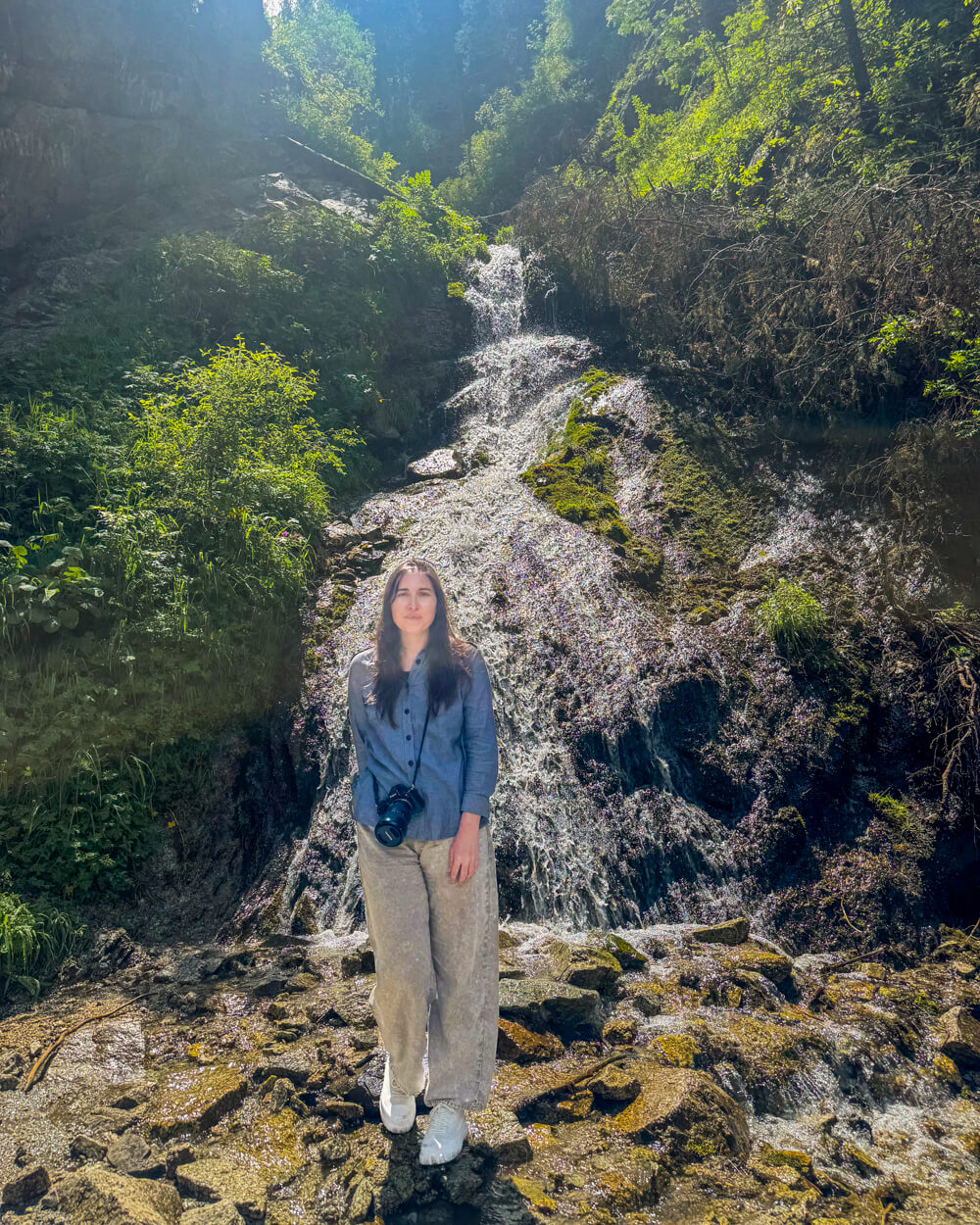 Allison Green, the author of the article, standing in front of a waterfall