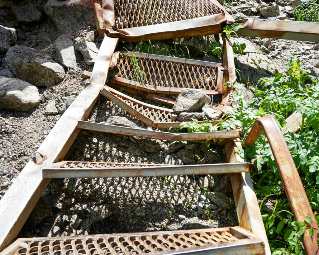 Rusty and broken stairs near the waterfall