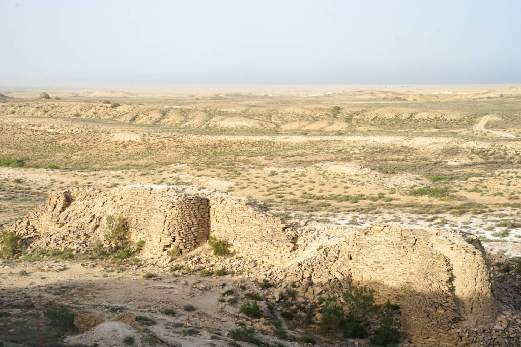 Fortress or caravanserai near the yurt camp and with a view of the Aral Sea in the background