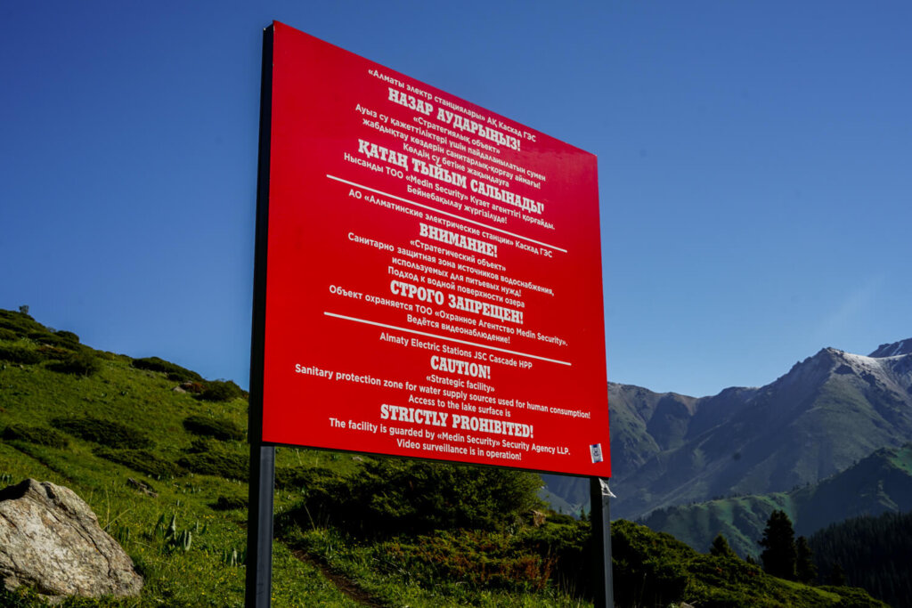 Red sign saying no swimming and that it's under surveillance