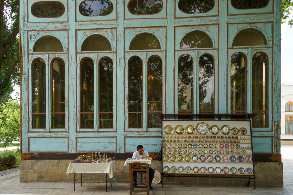 A man selling wares outside the old chaikhana (teahouse) attached to the main palace building