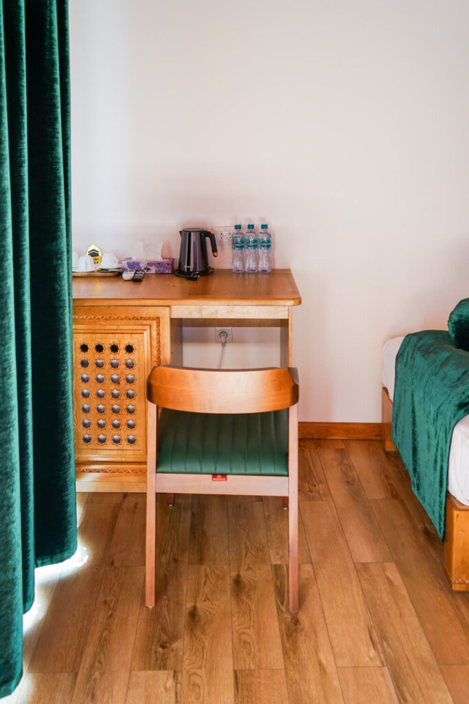 Green detail and a work desk with bottled water and kettle