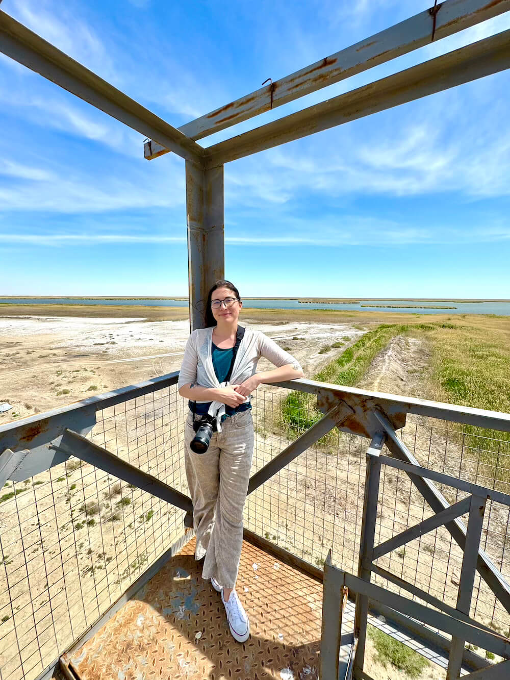 Allison at the Sudochye lake in Karakalpakstan wearing culturally appropriate clothing that was also comfortable for active travel
