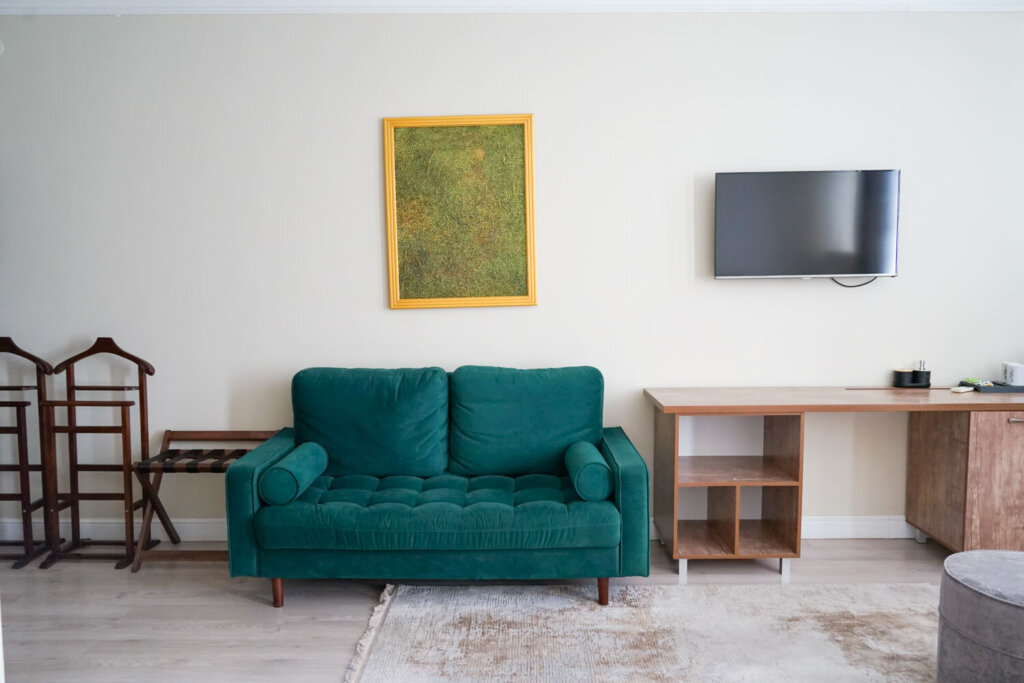 Interior of the Jipek Joli Hotel with a green couch