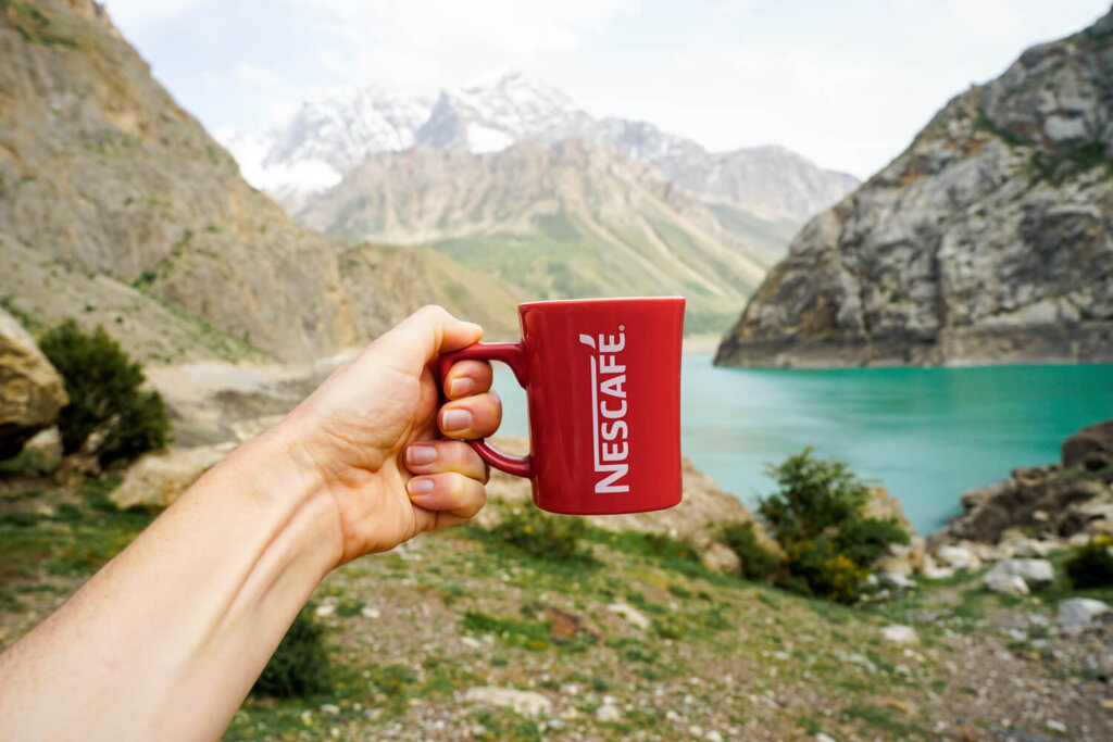 Allison's hand holding a red nescafe cup