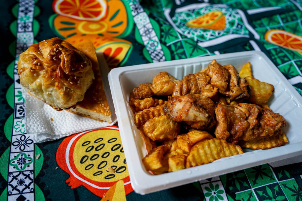 Chicken kabob, potatoes, samsa and bread on a picnic blanket in a mountain guesthouse in Tajikistan