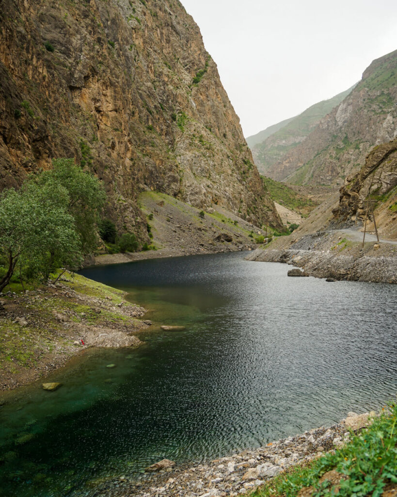 The first lake you approach in the Seven Lakes in Tajikistan, a dark blue color with a curved shape