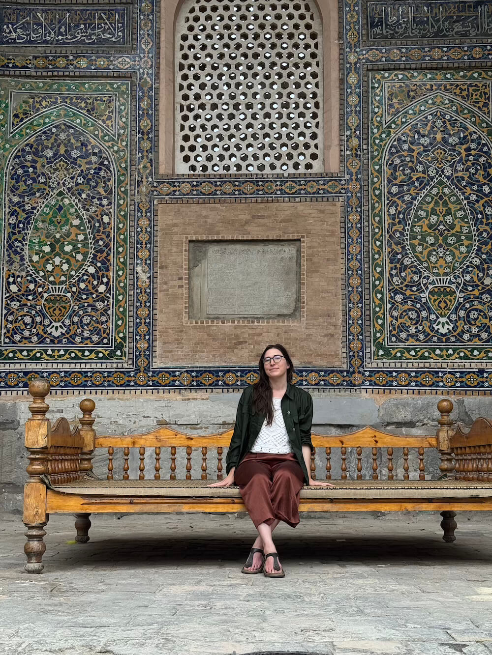 A fully modest outfit in Samarkand, wearing green shirt, white top, and silk pants.