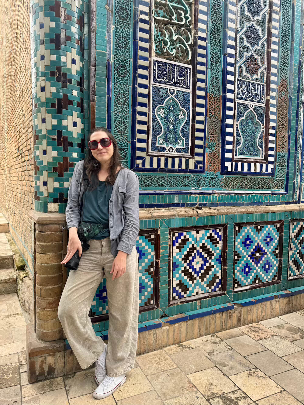Another example of respectful clothing in Uzbekistan: blue-gray chambray shirt, blue tank top, baggy jeans, and converses, wearing red sunglasses