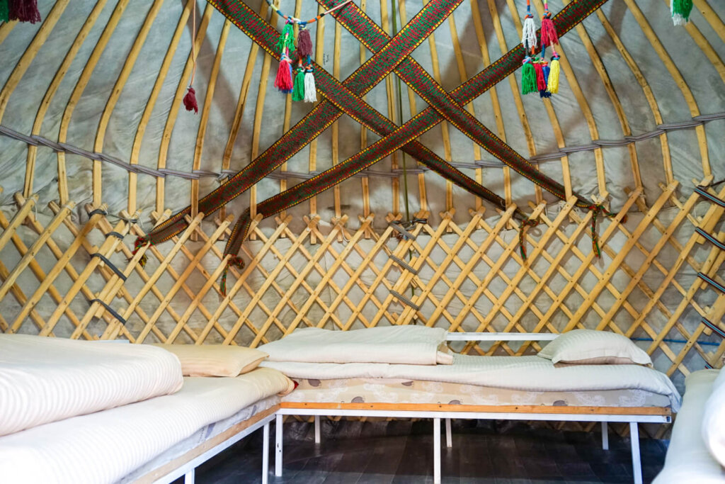 Interior of the yurt with its decorative elements and multiple beds